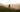 A dog and owner walking in the countryside into the sun.