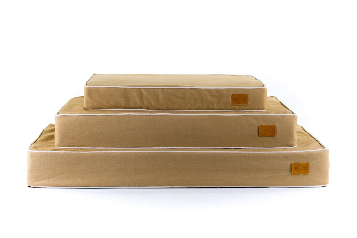 Cream and sand stack of Classic Natural luxury dog beds. Made in Britain using organic materials and British wool.