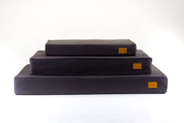 Stack of charcoal Classic natural beds for dogs by Hixx. Made in Britain.